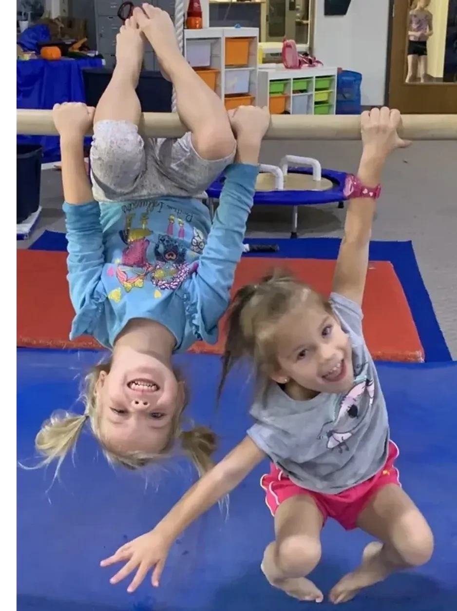 Gymnastics coach and children working together